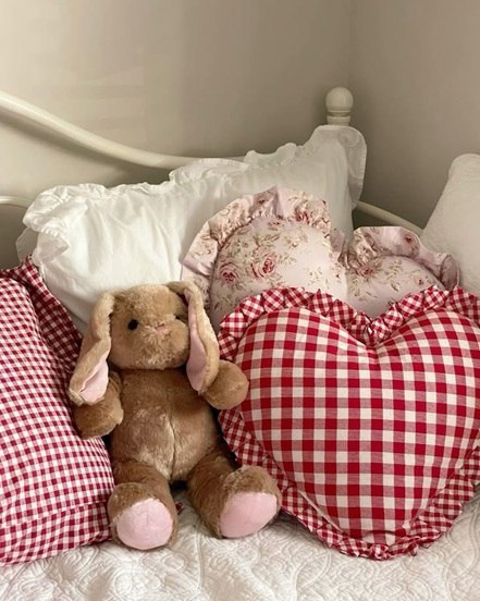 Red Gingham pillows, ruffled bedding, and plush toys